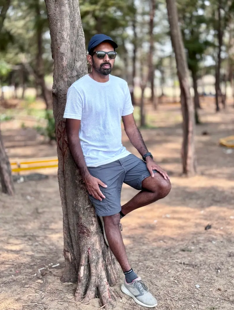 Tijo leaning against a tree